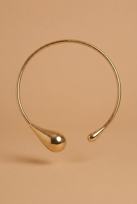 Close-up of the Odette chunky gold chain choker worn high on the neck for evening dressing