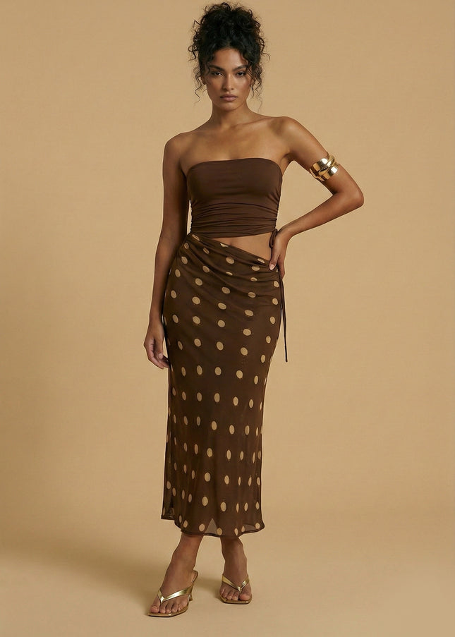 Chocolate brown strapless bandeau dress with a ruched waist and sheer polka dot maxi skirt