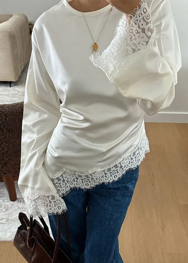 Semi-sheer patchwork lace blouse with a lace-up neckline and irregular hem